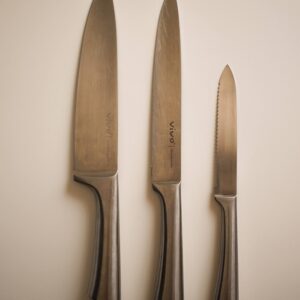 a couple of knives and a knife on a wall