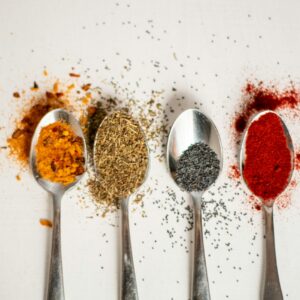 a row of spoons filled with different types of spices